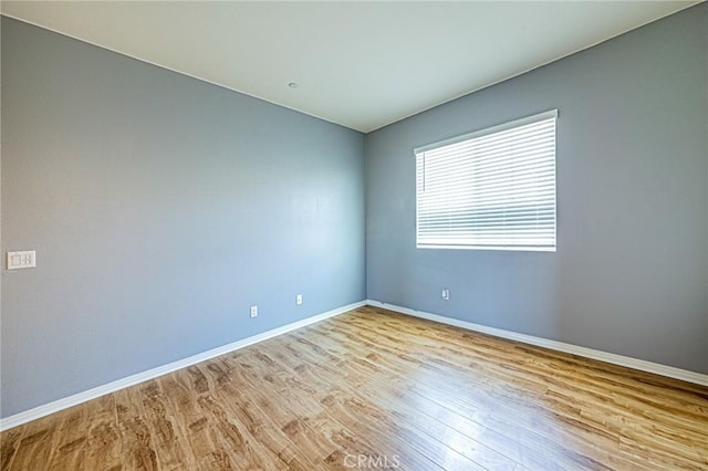 unfurnished room with light wood-type flooring