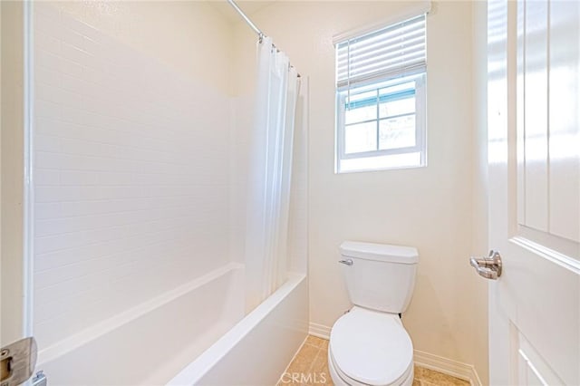 bathroom featuring tile patterned flooring, toilet, and shower / tub combo with curtain