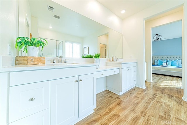 bathroom featuring vanity and hardwood / wood-style floors