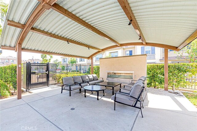 view of patio featuring an outdoor living space with a fireplace