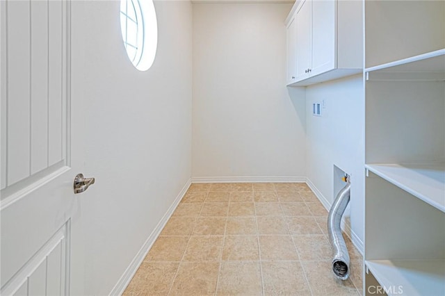 laundry area featuring washer hookup, cabinets, and light tile patterned flooring