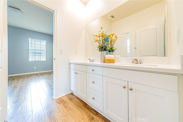 bathroom featuring vanity and hardwood / wood-style floors