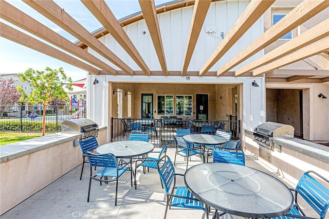 view of patio featuring a grill, a pergola, and exterior kitchen