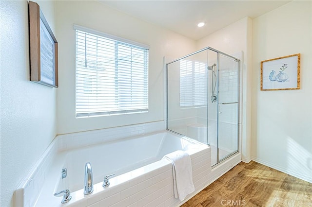 bathroom featuring separate shower and tub and hardwood / wood-style flooring