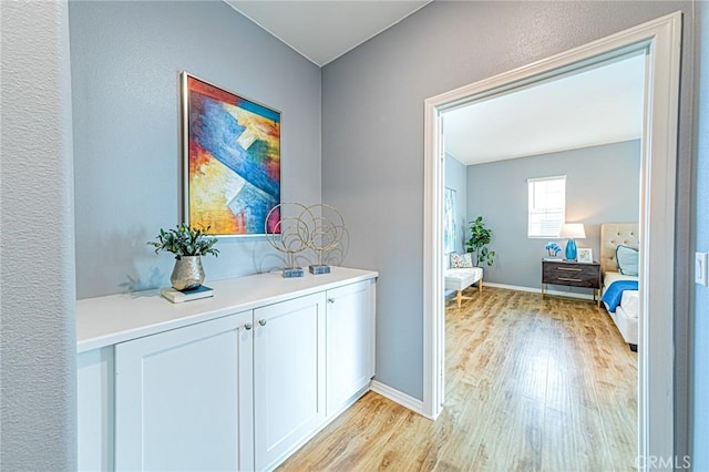 hallway with light hardwood / wood-style flooring