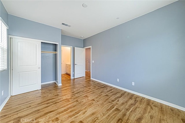 unfurnished bedroom with light hardwood / wood-style floors and a closet