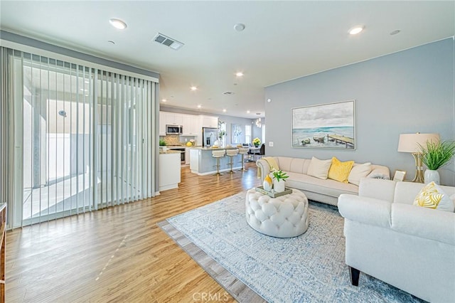 living room with light hardwood / wood-style flooring