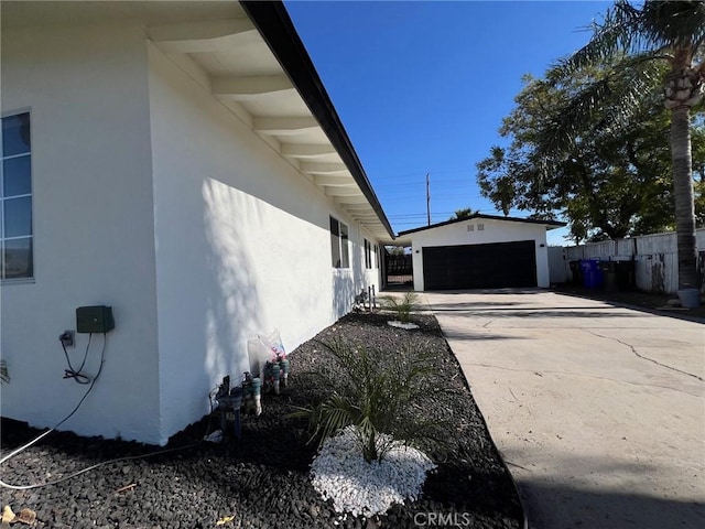 view of side of home featuring an outbuilding and a garage