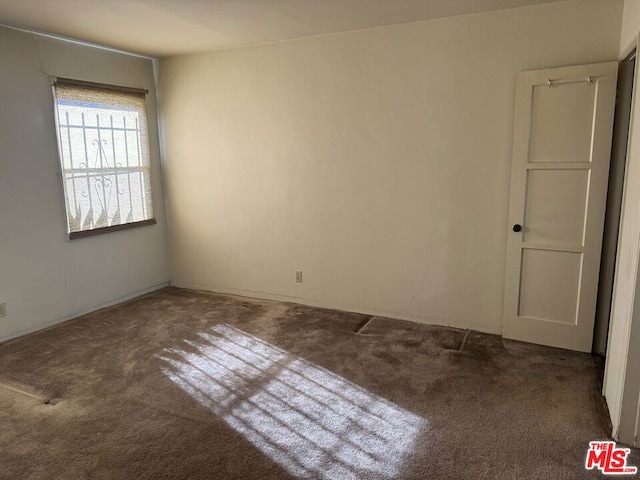 empty room with dark carpet