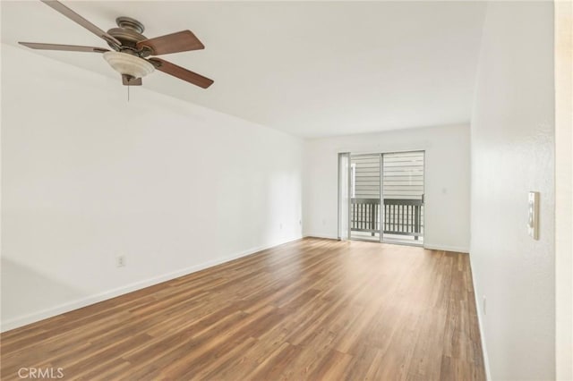 unfurnished room with ceiling fan and hardwood / wood-style flooring