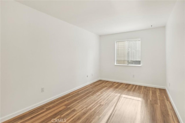 spare room with hardwood / wood-style floors