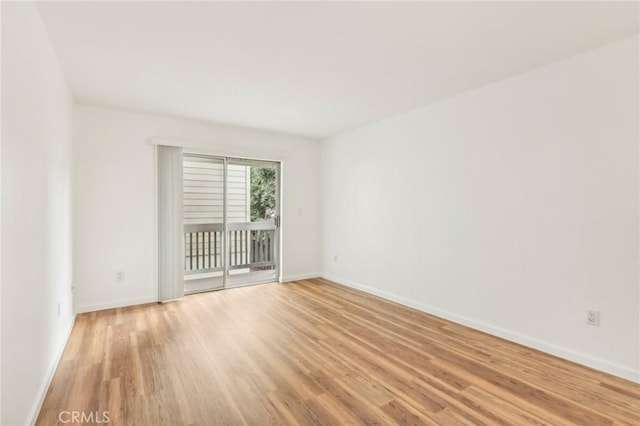 empty room with light hardwood / wood-style flooring