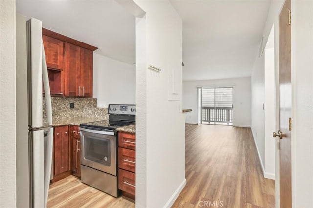 kitchen featuring stainless steel range with electric cooktop, tasteful backsplash, refrigerator, light stone counters, and light hardwood / wood-style flooring