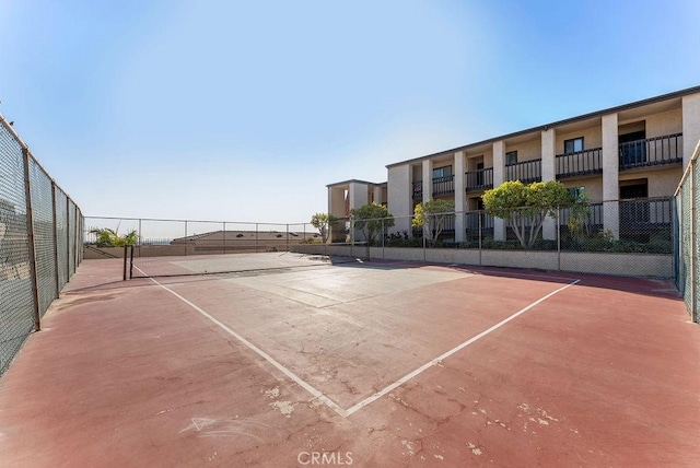 view of sport court with basketball hoop