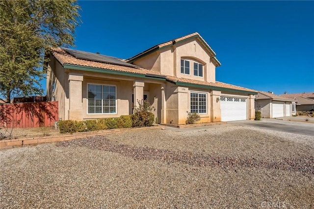 view of front of property with solar panels and a garage