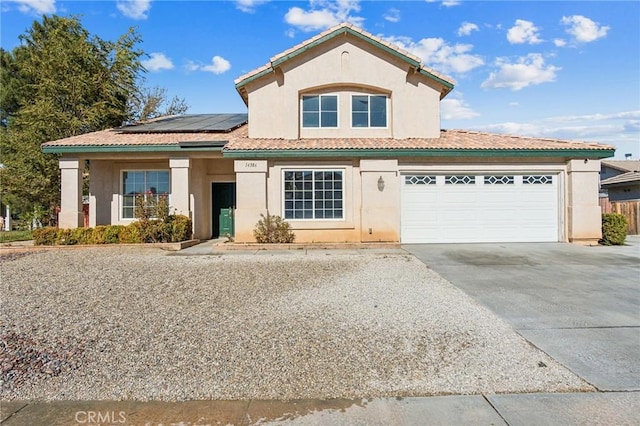 view of front of property with solar panels and a garage