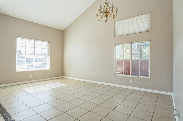 empty room with a notable chandelier, light tile patterned flooring, and high vaulted ceiling