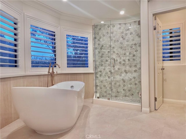 bathroom with crown molding and shower with separate bathtub