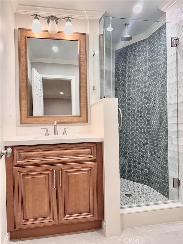 bathroom with tile patterned flooring, crown molding, a shower with shower door, and vanity