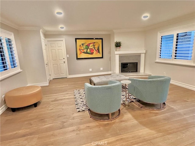 living room with crown molding and light hardwood / wood-style flooring