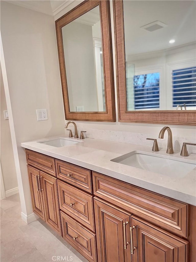 bathroom featuring vanity and ornamental molding