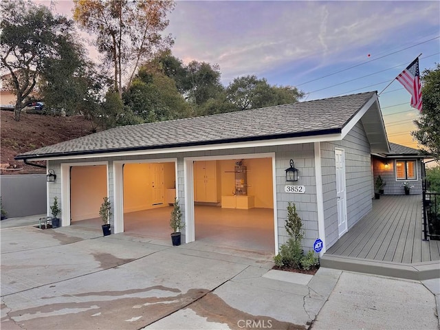 view of garage at dusk