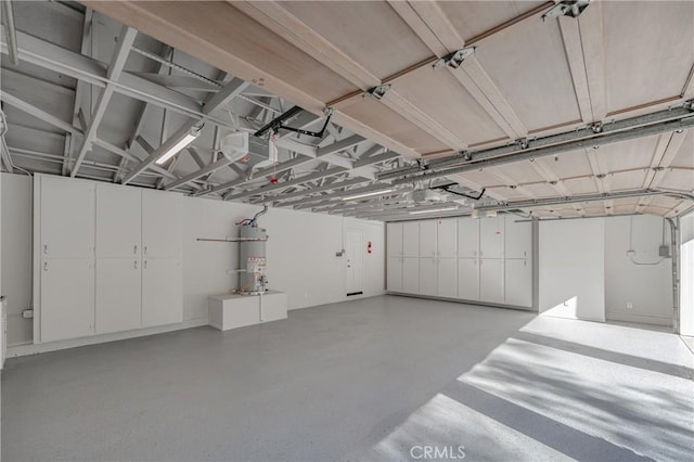 garage with water heater and a garage door opener