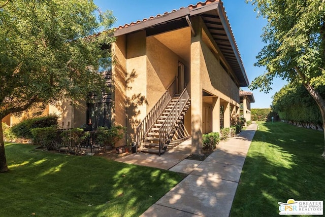 view of side of home featuring a lawn