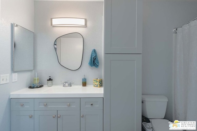 bathroom featuring vanity and toilet