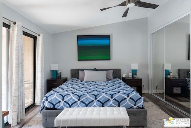 bedroom featuring ceiling fan, a closet, hardwood / wood-style floors, and lofted ceiling