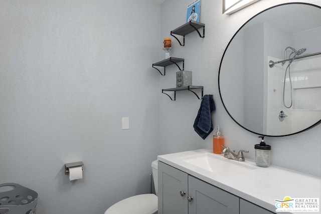 bathroom with vanity, toilet, and walk in shower