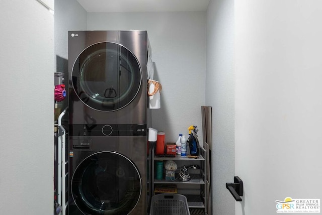 laundry room with stacked washing maching and dryer