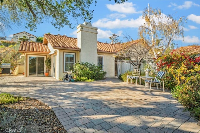 rear view of house featuring a patio