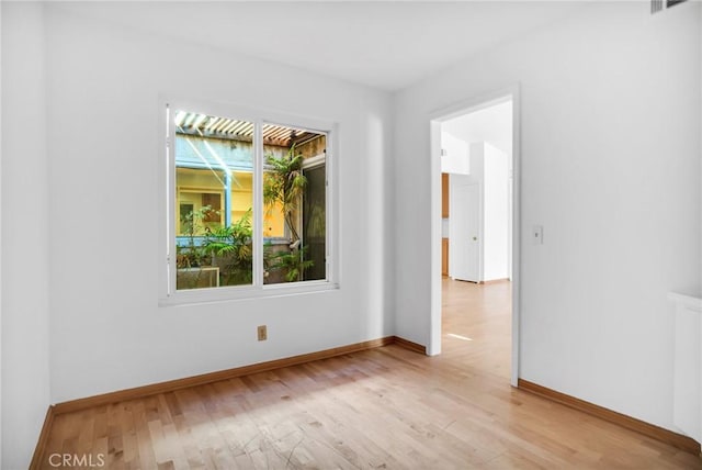 spare room featuring light hardwood / wood-style flooring