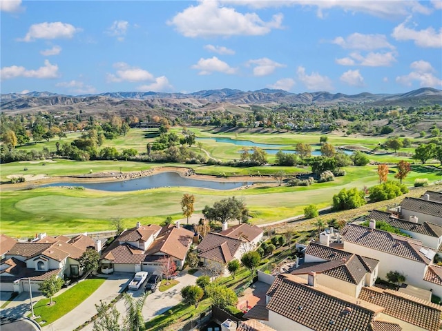 birds eye view of property with a water and mountain view