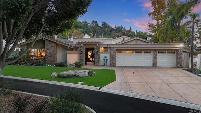 view of front facade with a lawn and a garage