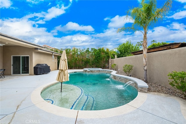 view of swimming pool with pool water feature, a patio area, and grilling area