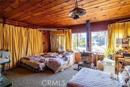 carpeted bedroom with wood ceiling