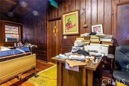 interior space featuring hardwood / wood-style floors and wooden walls