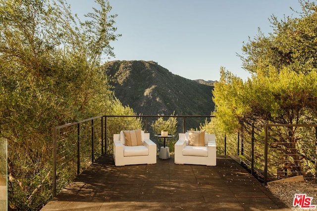 exterior space featuring outdoor lounge area and a mountain view