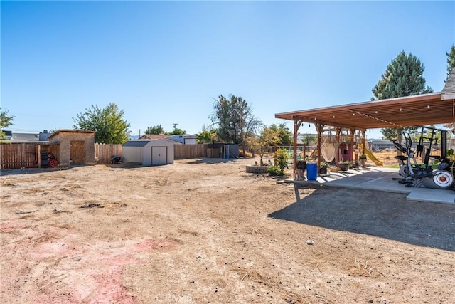 view of yard featuring a playground and a shed