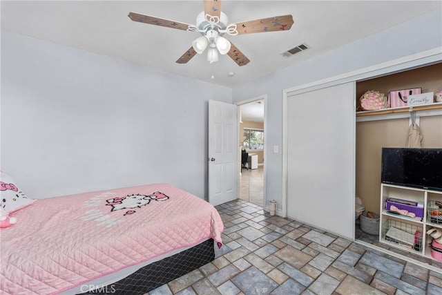 bedroom featuring ceiling fan and a closet