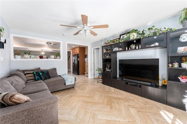 living room with ceiling fan and light parquet floors