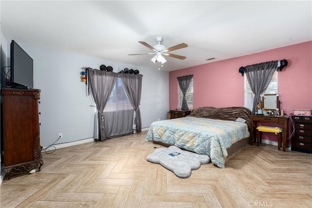 bedroom with ceiling fan and light parquet floors