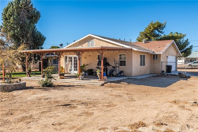 rear view of property with a garage