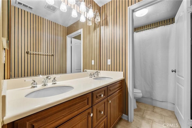 bathroom with tile patterned floors, vanity, and toilet