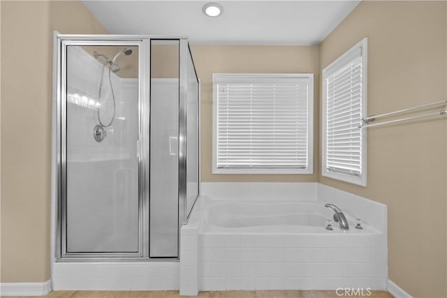 bathroom with tile patterned floors and separate shower and tub