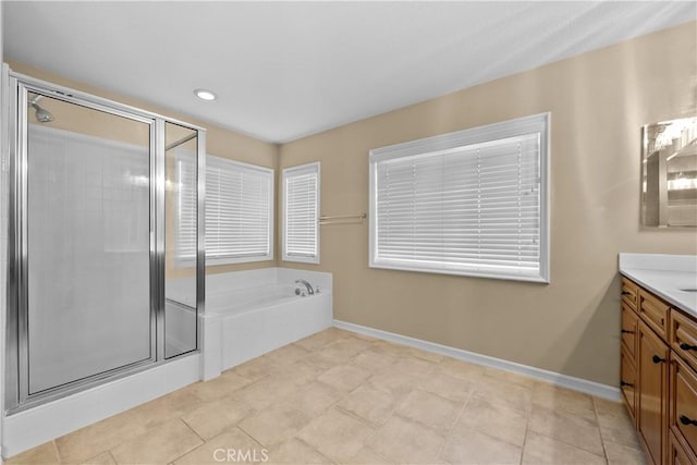 bathroom featuring tile patterned floors, vanity, and separate shower and tub