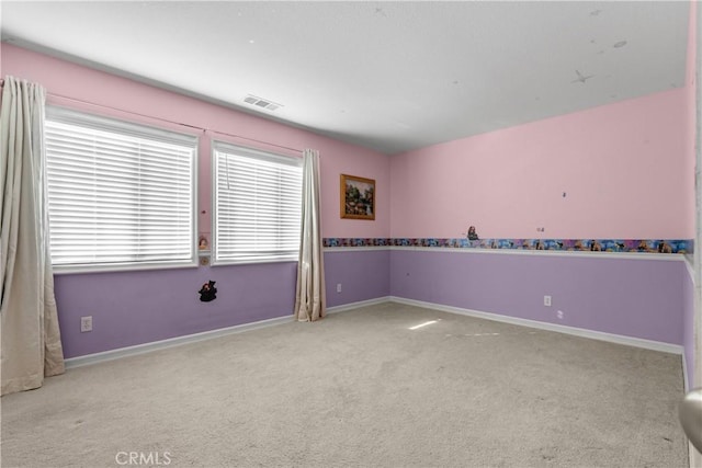 unfurnished room featuring light carpet