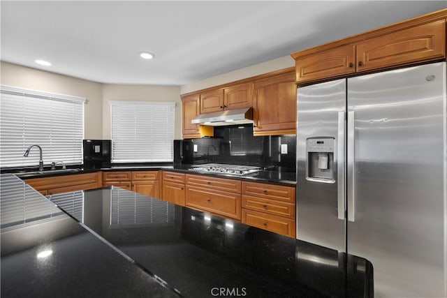 kitchen featuring backsplash, sink, and appliances with stainless steel finishes